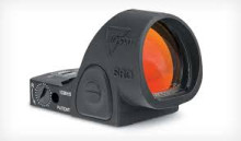 The Trijicon SRO is a high-performance red dot sight built for speed. Designed specifically for competitive shooting, it features a large, round window that gives you a massive field of view. This makes it incredibly easy to find the dot quickly and track it while transitioning between multiple targets. It shares the durable 7075-aluminum construction and mounting footprint of the legendary RMR but adds a top-loading battery so you don't have to re-zero when changing power.
